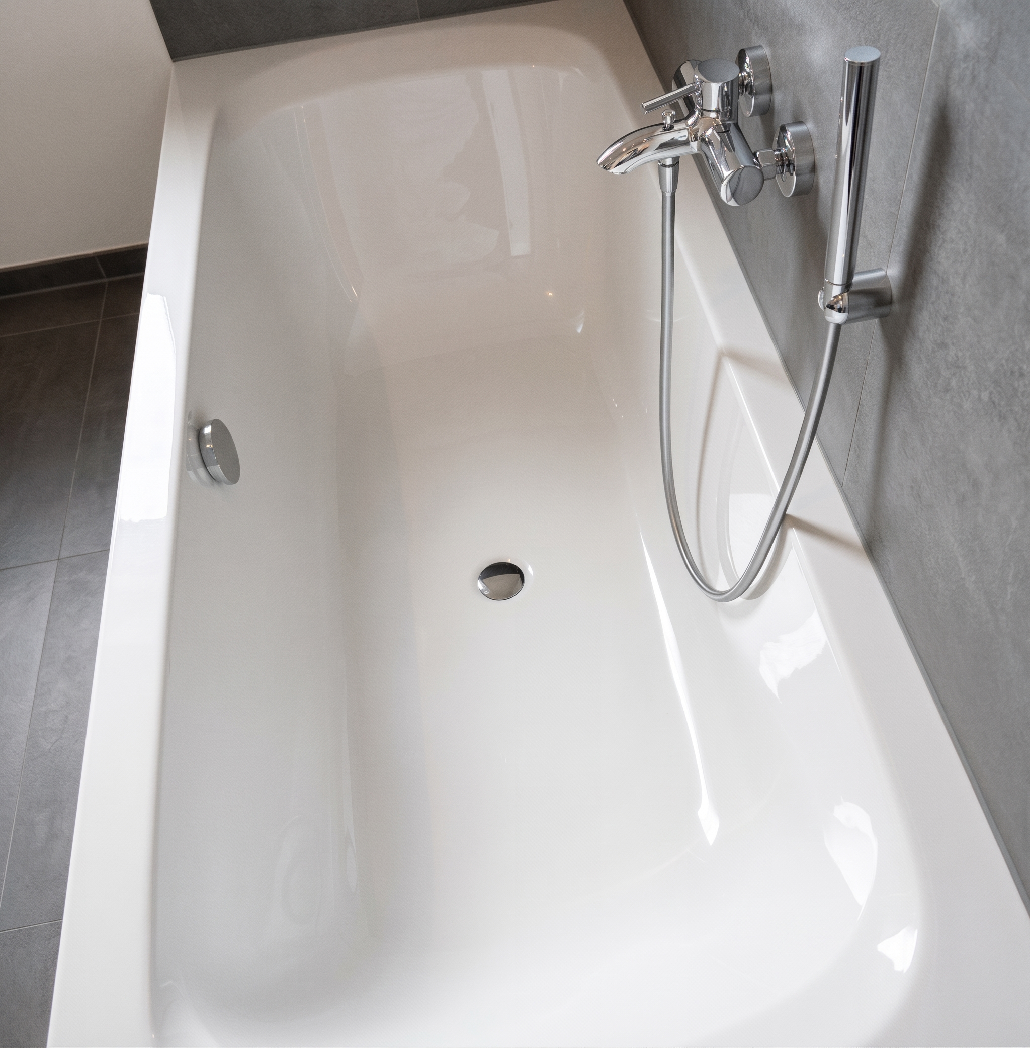 Gleaming white bathtub with chrome tap after a SaMa bathroom clean